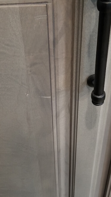 Picture of Scratches on cabinet doors in the new Keystone Montana RV.